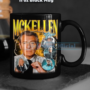 May include: A black 11 oz mug with a graphic of Ian McKellen and other actors from the Lord of the Rings movies. The mug has a white background with a yellow lightning bolt design. The text "McKellen" is in yellow letters and the text "Ian" is in blue letters.