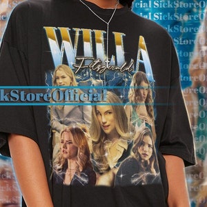 May include: Black oversized t-shirt featuring a graphic print of a collage of women's faces and the text "WILLA Fitzgerald".