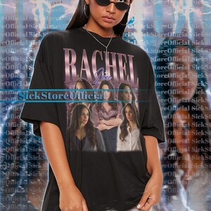 May include: Black unisex t-shirt featuring a graphic of the name "RACHEL" with a photo collage of a woman. The shirt has short sleeves and a crew neck. The text "SickStoreOfficial" is also visible.
