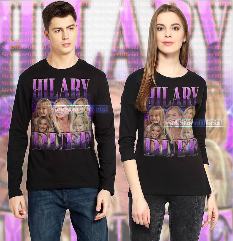 May include: Black long-sleeve shirts featuring a graphic of Hilary Duff with the text "HILARY DUFF" in a purple gradient. The shirts are worn by a man and a woman, both wearing dark jeans.