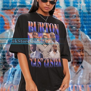May include: Black oversized t-shirt featuring a graphic of several men with the name "BURTON" above and "GUS GUSTER" below. The shirt is a unisex style and the model is wearing a 2XL size.
