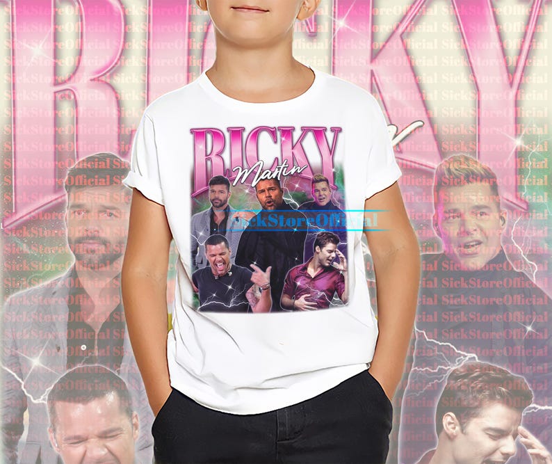 May include: White t-shirt featuring a retro design with the text "Ricky Martin" in pink, along with multiple images of the singer. The design has a vintage aesthetic with a faded background.