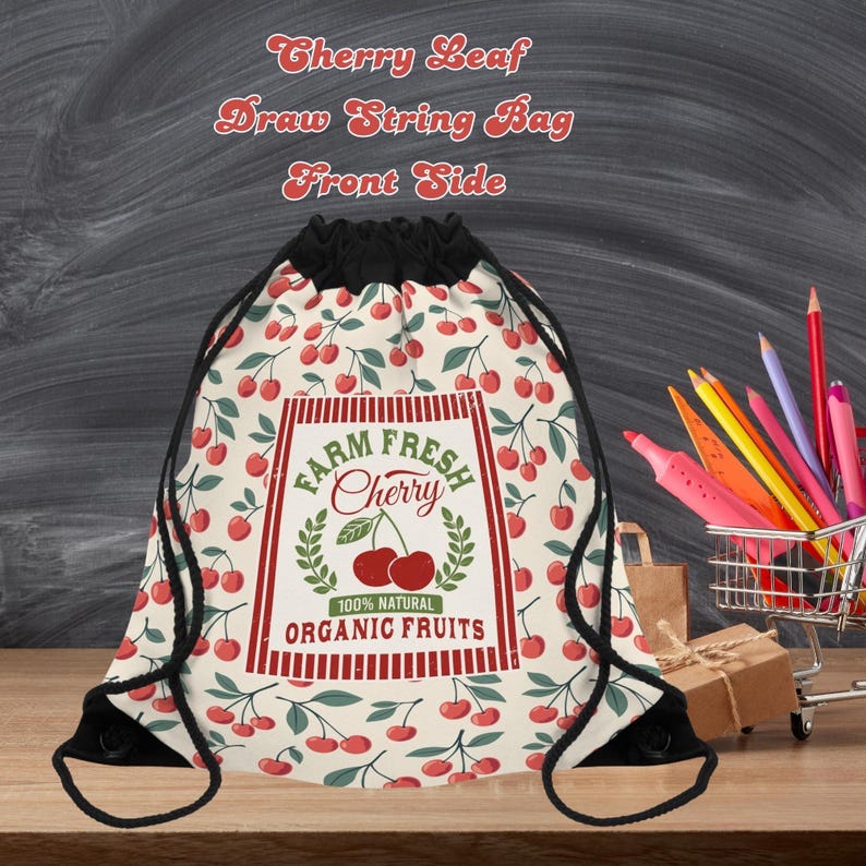 May include: A drawstring bag with a cherry leaf pattern and the text "Farm Fresh Cherry." The bag features a black drawstring closure and a cream-colored background with red cherries and green leaves. The bag is made of a lightweight fabric.