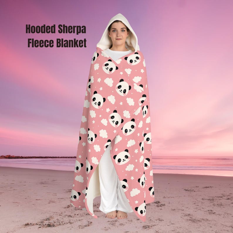 Wrap yourself in comfort with this cozy Hooded Sherpa Fleece Blanket, perfect for chilly evenings or lazy weekends at home. Designed with a charming panda print on a soft pink background, this blanket radiates a fun and comfy vibe that enhances your relaxation moments. Whether you're binge-watching your favorite show, reading a book, or enjoying a cozy night in, this blanket adds a touch of joy to your everyday life.