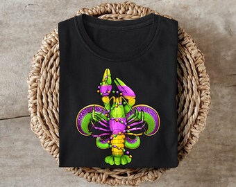 May include: Black t-shirt with a green, purple, and gold Mardi Gras themed crawfish design.