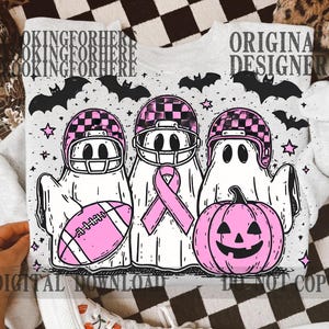 May include: A light gray sweatshirt featuring a Halloween-themed design. The graphic includes three ghost figures wearing football helmets, holding a football, and a pink pumpkin. The text "LOOKINGFORHER" and "ORIGINAL DESIGNER" are also visible.