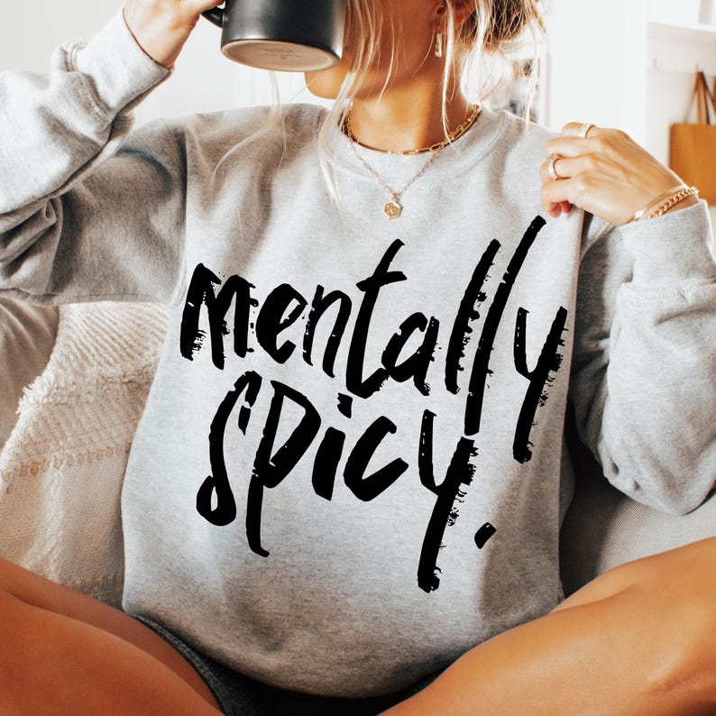 May include: A gray sweatshirt with the text "mentally spicy" printed in black.