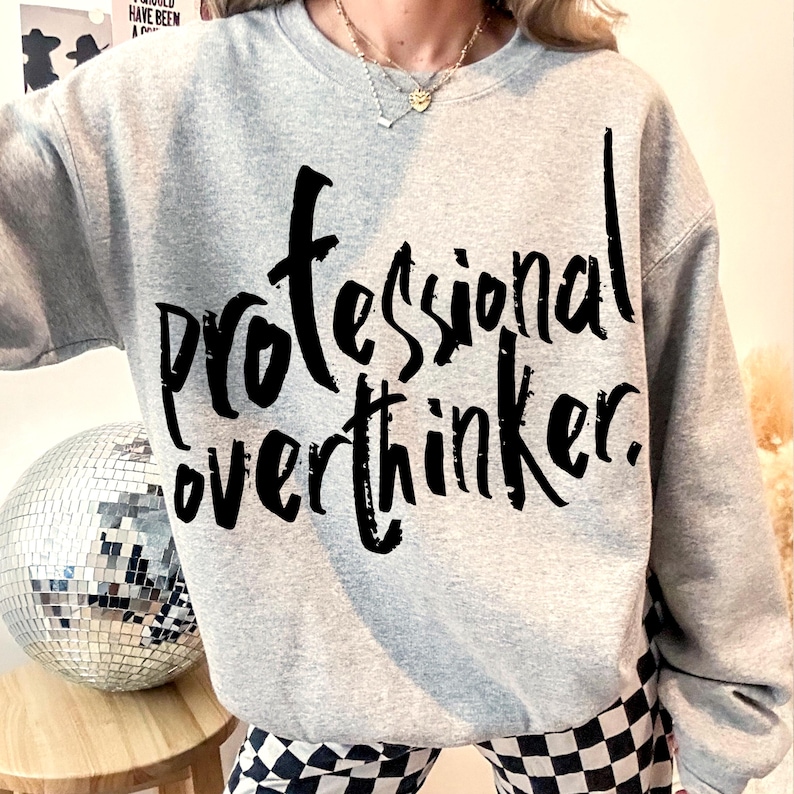 May include: Gray sweatshirt with black text that reads "professional overthinker."