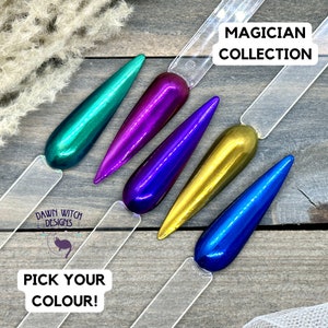 May include: Five metallic nail polish colors in a teardrop shape on clear sticks. The colors are teal, purple, blue, gold, and blue. The text "MAGICIAN COLLECTION" is at the top of the image. The text "PICK YOUR COLOUR!" is at the bottom of the image.