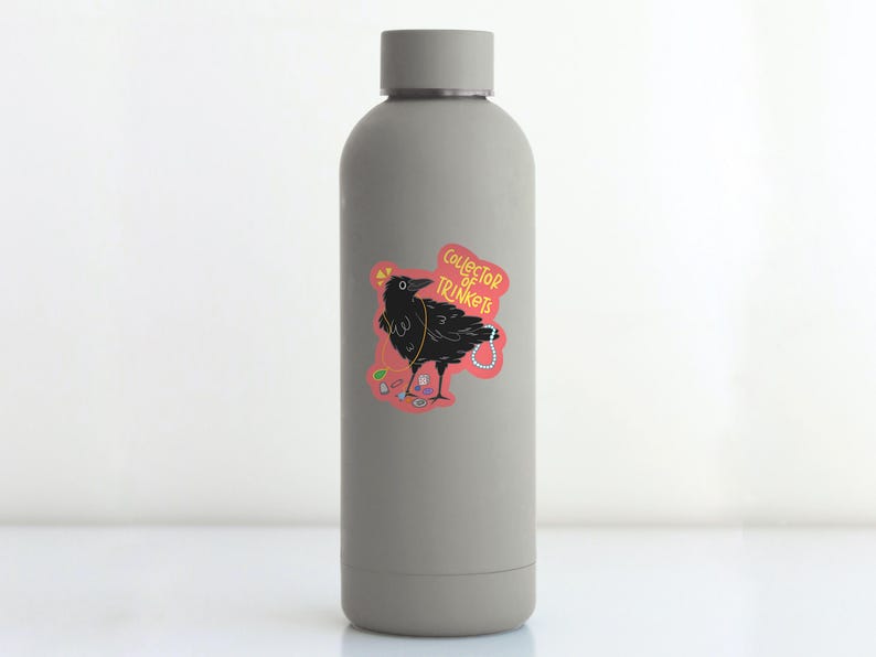May include: A gray water bottle with a sticker of a black crow with a pearl necklace and the text "Collector of Trinkets".