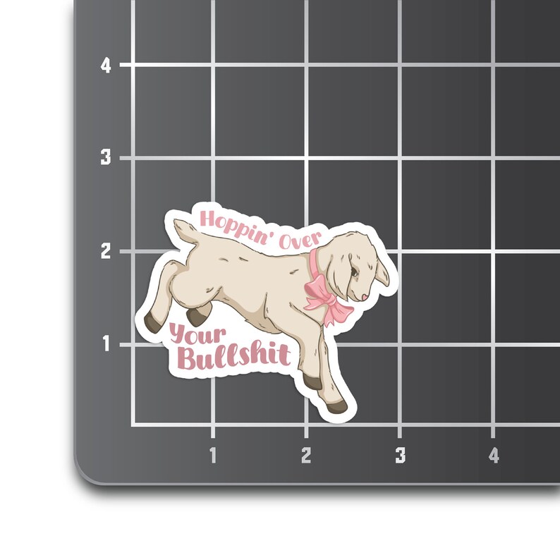 May include: A white lamb with a pink bow, jumping over the text "Hoppin' Over Your Bullshit".