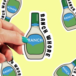 May include: A white sticker with a cartoon drawing of a bottle of ranch dressing. The bottle is green and white with the word "RANCH" printed on it. The sticker has the text "RANCH WHORE" printed around the bottle.