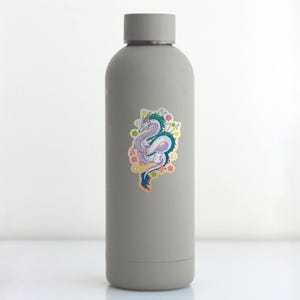 May include: A gray water bottle with a sticker of a colorful dragon with pink, blue, and green scales. The dragon is surrounded by pink, yellow, and blue flowers.