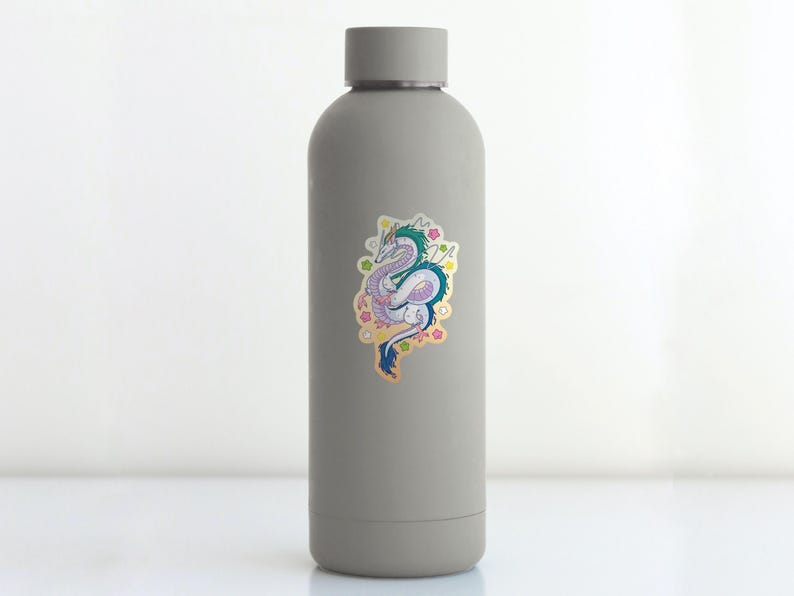 May include: A gray water bottle with a sticker of a colorful dragon with pink, blue, and green scales. The dragon is surrounded by pink, yellow, and blue flowers.