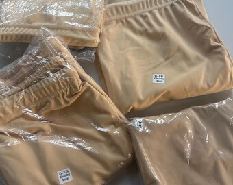 May include: Four packages of beige leggings with a white label that reads "XL-XXL Chubby Maxi".