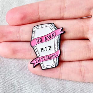 Go Away Coffin Enamel Pin — White Coffin with Pink Ribbons, “I’m Sleeping” | For Jackets, Ita Bags, Backpacks, Pin Boards, Festivals