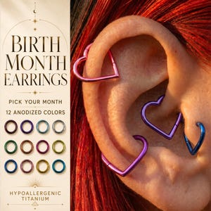 May include: Heart-shaped hoop earrings in various anodized colors including pink, purple, and blue. The text on the left reads Birth Month Earrings, Pick Your Month, 12 Anodized Colors, and Hypoallergenic Titanium, with a grid of 12 circular icons.