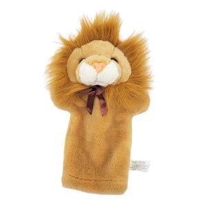 May include: A brown plush lion hand puppet with a brown bow tie. The puppet has a white face with a pink nose and black eyes.