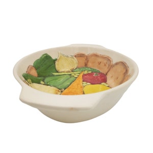 May include: White ceramic soup bowl with a hand-painted design of vegetables, including carrots, onions, peppers, and peas. The bowl has two handles on the sides.