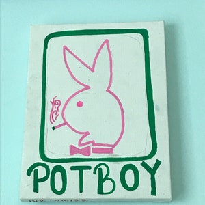 May include: A green square with a pink bunny rabbit smoking a cigarette inside. The bunny is wearing a green bow tie. The text "POTBOY" is written in green below the square.