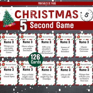 May include: A set of 126 Christmas-themed game cards with red and white stripes. Each card has a different challenge for a 5-second game. The cards are printed with the text "Name 3" and a Christmas-themed prompt.