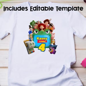 May include: A white short-sleeved t-shirt featuring a graphic print of various animated toy characters surrounding a green frog-shaped frame. The frame contains the text Kasey Turns 4 in yellow and red lettering. The design includes multiple colourful figures.