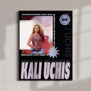May include: A framed poster featuring Kali Uchis. The poster has a black background with the artist's name in large, white and lavender letters. A photo of the artist is in the center, with song titles and listener stats. A light blue star shape is on the poster.