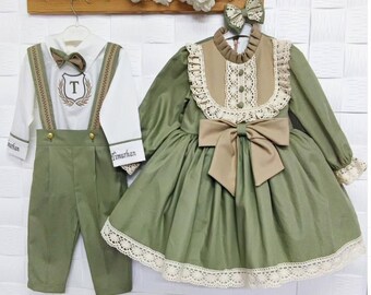 May include: A green and brown dress with lace trim and a large bow. The dress has a white collar and a white lace overlay. A matching headband with a bow is included. The dress is embroidered with the name "Timurhan".
