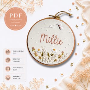 May include: An embroidery hoop with the name "Millie" stitched in a cursive font. The design includes a butterfly, daisies, and leaves. The text "PDF Embroidery Pattern" is in a circle at the top left. Additional text includes "Customizable Text", "Beginner Friendly", "Step-by-Step Guide", and "Printable Template".