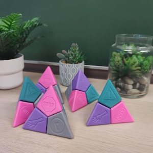 May include: Six triangular shaped puzzle pieces with different traffic signs on each side. The pieces are pink, purple, teal and gray. The signs include "Stop", "Yield", "Caution", "Keep Right", and "No Parking".