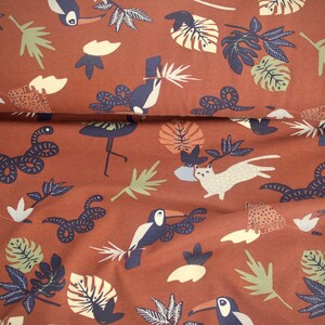 May include: Brown fabric with a repeating pattern of toucans, snakes, leopards, and jungle leaves. The fabric has a vintage feel and would be perfect for a variety of sewing projects.