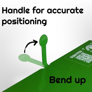 May include: A close-up of a green metal tool with a handle for accurate positioning. The text "Handle for accurate positioning" and "Bend up" are visible. An arrow indicates the handle's movement.