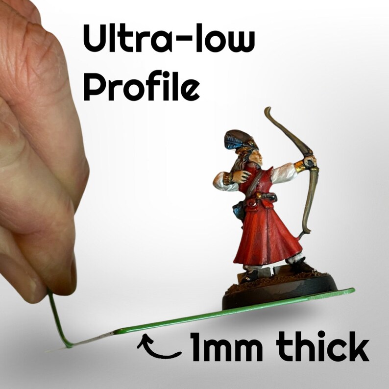 May include: A miniature archer figurine in a red and white outfit, holding a bow. The text "Ultra-low Profile" and "1mm thick" are displayed. A hand holds a thin green line, demonstrating the product's profile.