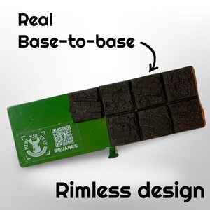 May include: A green tray with eight square, textured, dark gray bases. The bases are arranged in two rows of four. The tray has the text "Real Base-to-base" and "Rimless design". A sticker on the tray reads "Mini Mag Tray" and "Squares".