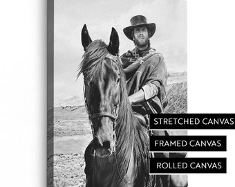 May include: Black and white canvas print of a man on horseback in a desert landscape. The image is available as stretched, framed, or rolled canvas. The text on the image reads "STRETCHED CANVAS", "FRAMED CANVAS", and "ROLLED CANVAS".