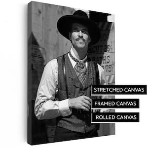 May include: Black and white canvas print featuring a man in a cowboy hat and vest. The image is available as stretched, framed, or rolled canvas. Text on the canvas reads "STRETCHED CANVAS, FRAMED CANVAS, ROLLED CANVAS".