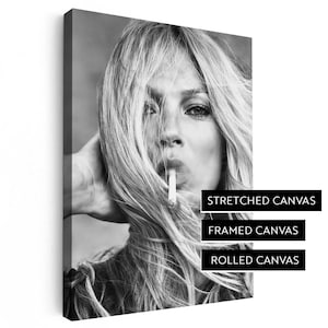 May include: Black and white photograph of a woman with long hair smoking a cigarette. The image is available as a stretched canvas, framed canvas, or rolled canvas.