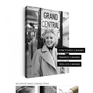 May include: Black and white canvas print featuring a smiling woman in a light-colored coat, standing in front of a "Grand Central" sign. The canvas options are stretched, framed, and rolled. The image is a portrait.
