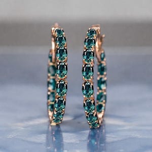 Teal sapphire hoop earrings, teal blue sapphire hoops, sapphire eternity hoop earrings, rose gold sapphire earrings, green blue gemstone hoops, luxury sapphire circle earrings, September birthstone earrings, oval cut sapphire hoops, fine jewelry hoop earrings, anniversary gift for her, statement sapphire earrings, elegant bridal sapphire hoops