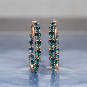 Teal sapphire hoop earrings, teal blue sapphire hoops, sapphire eternity hoop earrings, rose gold sapphire earrings, green blue gemstone hoops, luxury sapphire circle earrings, September birthstone earrings, oval cut sapphire hoops, fine jewelry hoop earrings, anniversary gift for her, statement sapphire earrings, elegant bridal sapphire hoops