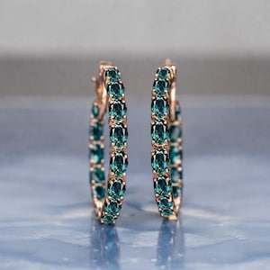 Teal sapphire hoop earrings, teal blue sapphire hoops, sapphire eternity hoop earrings, rose gold sapphire earrings, green blue gemstone hoops, luxury sapphire circle earrings, September birthstone earrings, oval cut sapphire hoops, fine jewelry hoop earrings, anniversary gift for her, statement sapphire earrings, elegant bridal sapphire hoops
