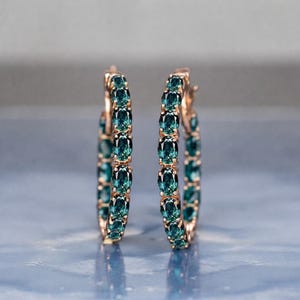 Teal sapphire hoop earrings, teal blue sapphire hoops, sapphire eternity hoop earrings, rose gold sapphire earrings, green blue gemstone hoops, luxury sapphire circle earrings, September birthstone earrings, oval cut sapphire hoops, fine jewelry hoop earrings, anniversary gift for her, statement sapphire earrings, elegant bridal sapphire hoops