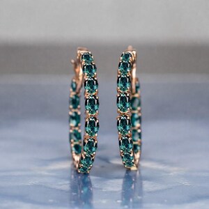 Teal sapphire hoop earrings, teal blue sapphire hoops, sapphire eternity hoop earrings, rose gold sapphire earrings, green blue gemstone hoops, luxury sapphire circle earrings, September birthstone earrings, oval cut sapphire hoops, fine jewelry hoop earrings, anniversary gift for her, statement sapphire earrings, elegant bridal sapphire hoops