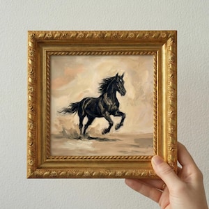 May include: A framed painting of a black horse running across a sandy landscape. The horse is the focal point, with its dark coat contrasting against the lighter background. The frame is gold-colored with ornate detailing.