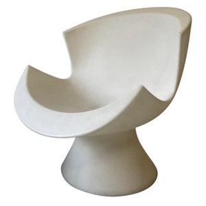 May include: A white, sculptural chair with a unique, organic design. The chair has a wide, rounded seat and a tall, slender base.