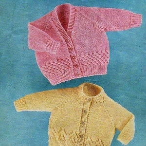 May include: Two knitted baby cardigans, one pink and one yellow, with button fastenings and a decorative stitch pattern.