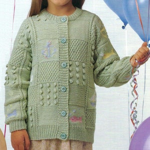 May include: A light green, button-down cardigan sweater with various textured knit patterns. The sweater features patches with embroidered anchors and fish. The child is holding balloons.