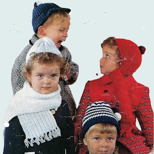 May include: Four children wearing winter hats and coats. The child on the left is wearing a blue hat, a white scarf, and a navy blue coat. The child in the center is wearing a white hat, a white scarf, and a navy blue coat. The child on the right is wearing a red hat, a red coat, and a plaid skirt. The child in the back is wearing a blue and white striped hat and a navy blue coat.