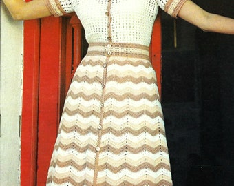 May include: A white crochet dress with brown and beige stripes. The dress has a button-up front and short sleeves.