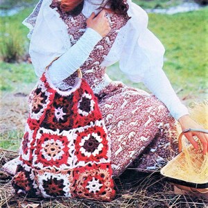 May include: A crocheted bag with a brown, red, and white pattern. The bag is made of squares and has a wooden handle.